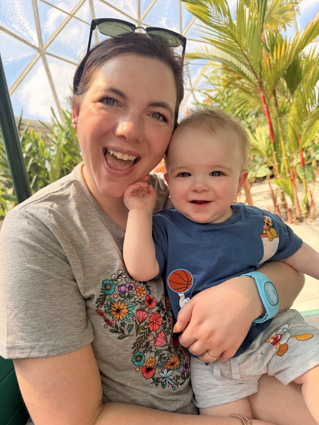Elainea laughing cheek-to-cheek with her son under the Epcot dome