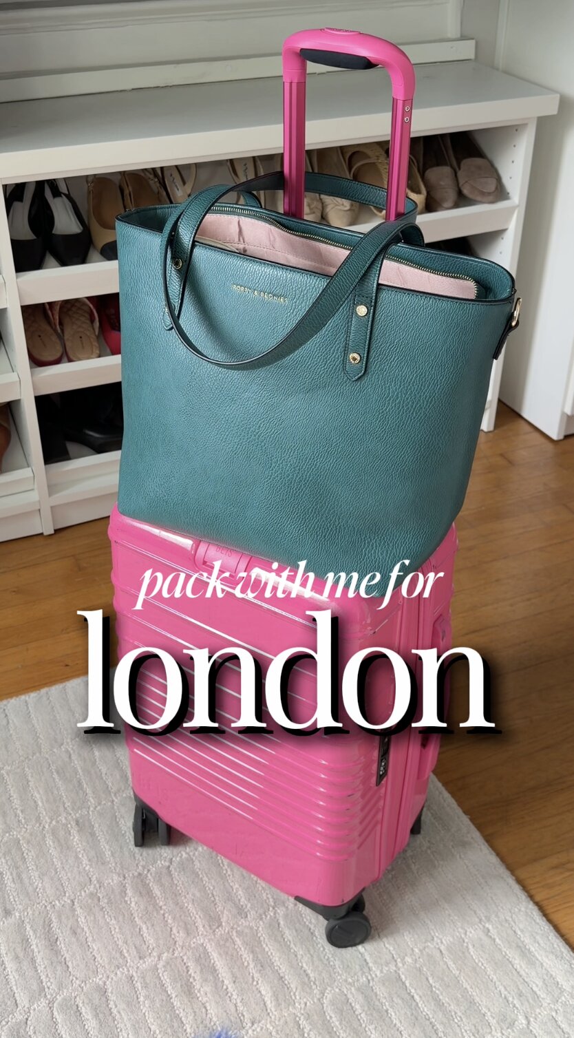 Pack with me for London — a teal tote stacked on a pink carry-on suitcase