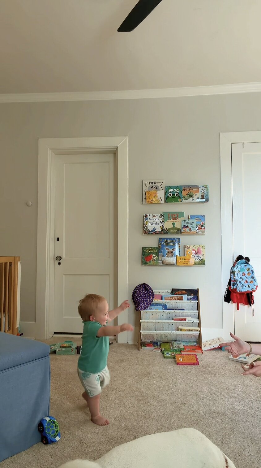 Candid moment of my toddler taking steps in the playroom